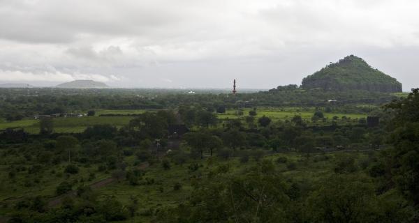View of Devagiri Fort, Daulatabad, Maharashtra. This photo illustrates part of an interesting optical illusion:  the minaret is actually almost the exact same height as the top of the fort on that hill, but from this distance it appears much smaller.  Taken with Canon 30D digital SLR. August 2008